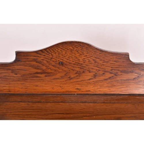 629 - A large Arts & Crafts 19th century carved oak open front trough bookcase. The bookcase having a shap... 