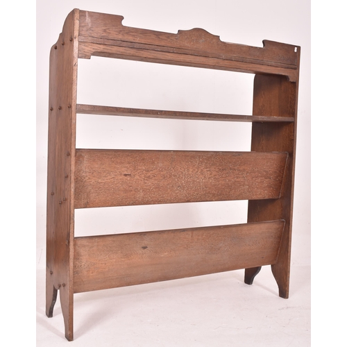 629 - A large Arts & Crafts 19th century carved oak open front trough bookcase. The bookcase having a shap... 