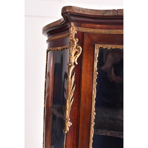 630 - A French Empire early 20th century serpentine fronted mahogany cabinet in the manner of Vernis Marti... 