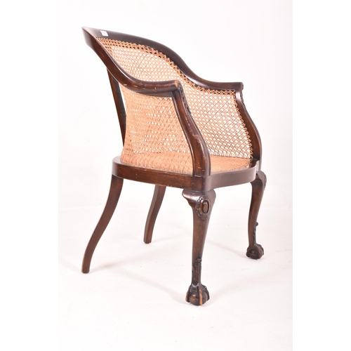 631 - Wylie & Lochhead Ltd. - an early 20th century Edwardian wicker and mahogany bergere library armchair... 