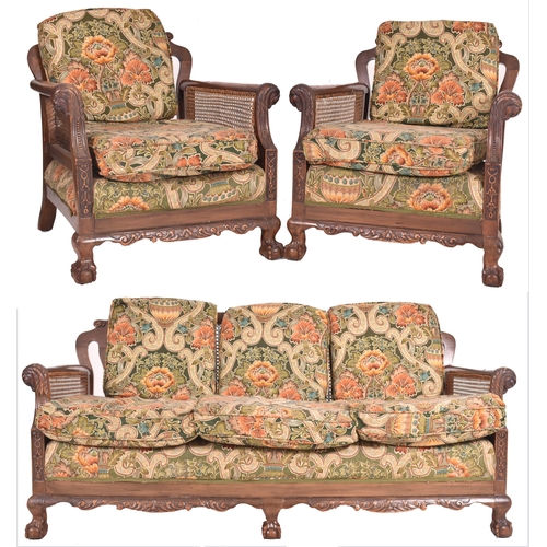 640 - An early 20th century three piece mahogany and double caned bergere suite. The suite comprising a th... 