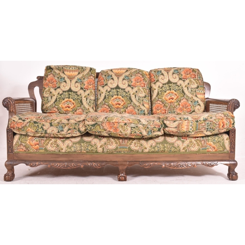 640 - An early 20th century three piece mahogany and double caned bergere suite. The suite comprising a th... 