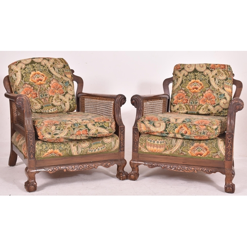 640 - An early 20th century three piece mahogany and double caned bergere suite. The suite comprising a th... 