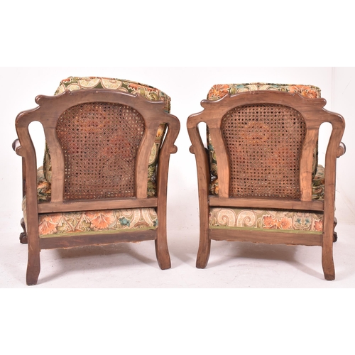 640 - An early 20th century three piece mahogany and double caned bergere suite. The suite comprising a th... 