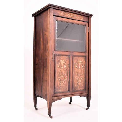 641 - An early 20th century Edwardian bone inlaid rosewood music cabinet. The cabinet having inlaid urn an... 