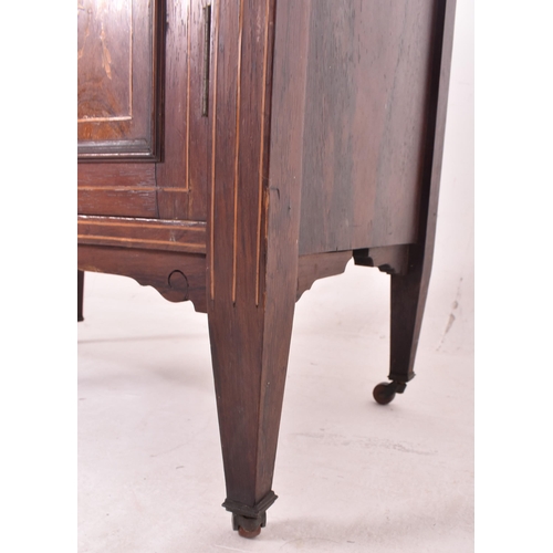 641 - An early 20th century Edwardian bone inlaid rosewood music cabinet. The cabinet having inlaid urn an... 