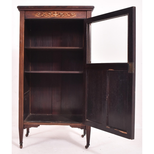 641 - An early 20th century Edwardian bone inlaid rosewood music cabinet. The cabinet having inlaid urn an... 