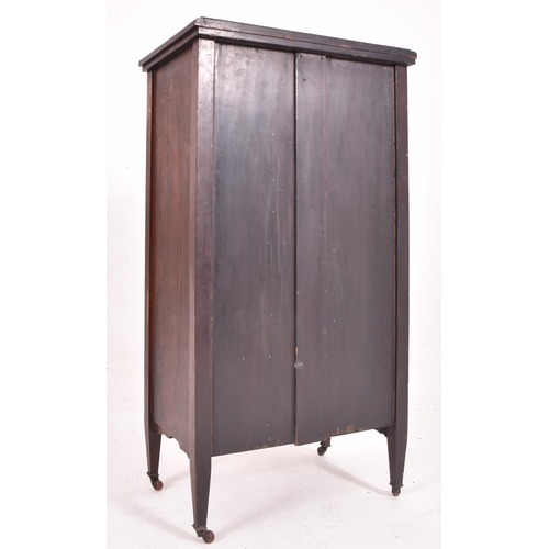 641 - An early 20th century Edwardian bone inlaid rosewood music cabinet. The cabinet having inlaid urn an... 