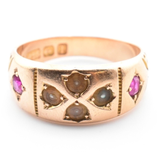 21 - A 19th century Victorian 15ct gold and gem set ring. The ring set with two rubies and four well worn... 