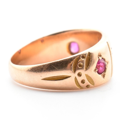 21 - A 19th century Victorian 15ct gold and gem set ring. The ring set with two rubies and four well worn... 