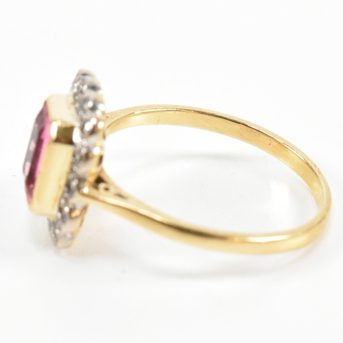 23 - A hallmarked 18ct gold pink tourmaline and diamond halo ring. The ring set with a central emerald cu... 