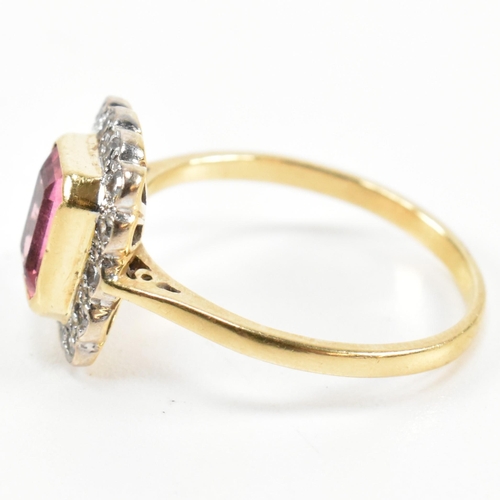 23 - A hallmarked 18ct gold pink tourmaline and diamond halo ring. The ring set with a central emerald cu... 