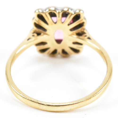 23 - A hallmarked 18ct gold pink tourmaline and diamond halo ring. The ring set with a central emerald cu... 