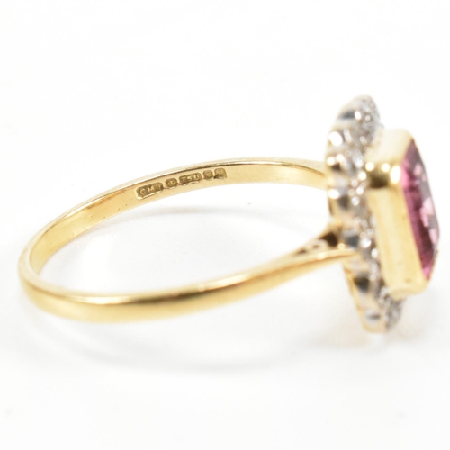 23 - A hallmarked 18ct gold pink tourmaline and diamond halo ring. The ring set with a central emerald cu... 