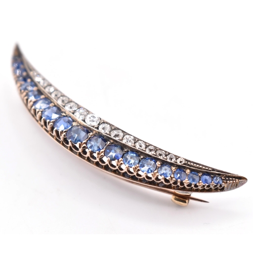 26 - A sapphire and diamond crescent brooch pin. The late 19th century/early 20th century crescent brooch... 