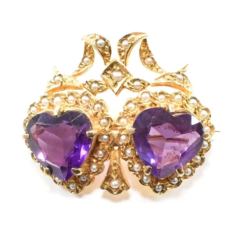 47 - A hallmarked 9ct yellow gold, amethyst and  pearl brooch pin. The antique style twin heart brooch ha... 