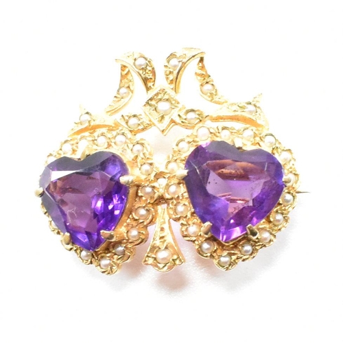 47 - A hallmarked 9ct yellow gold, amethyst and  pearl brooch pin. The antique style twin heart brooch ha... 