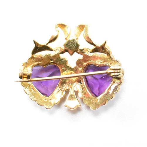 47 - A hallmarked 9ct yellow gold, amethyst and  pearl brooch pin. The antique style twin heart brooch ha... 