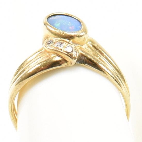 49 - An 18ct gold, diamond and opal ring. The ring having a central bezel set opal flanked by three round... 