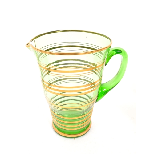 120 - A mid 20th Century retro glass green lemonade set with gold gilt circular ring detailing to body. Co... 