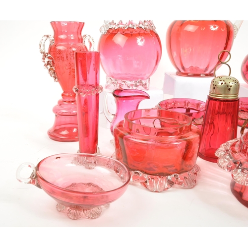 124 - A large collection of mid Century vintage cranberry glassware items to include jugs, bowls, vases, b... 