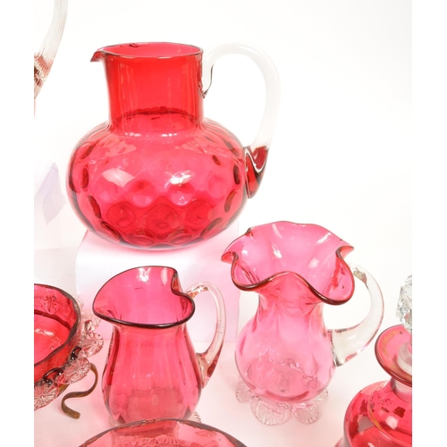 124 - A large collection of mid Century vintage cranberry glassware items to include jugs, bowls, vases, b... 