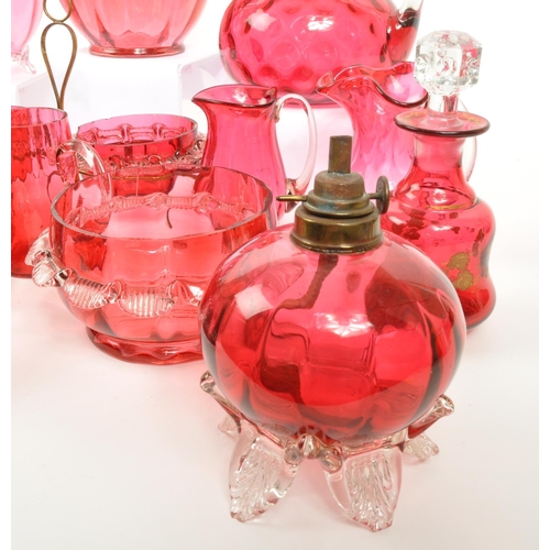 124 - A large collection of mid Century vintage cranberry glassware items to include jugs, bowls, vases, b... 