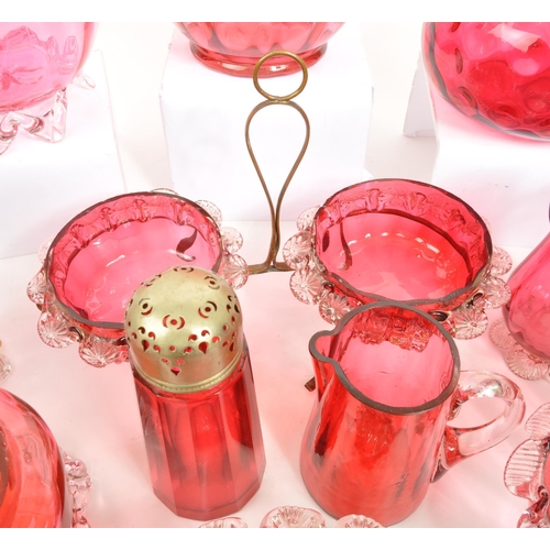 124 - A large collection of mid Century vintage cranberry glassware items to include jugs, bowls, vases, b... 