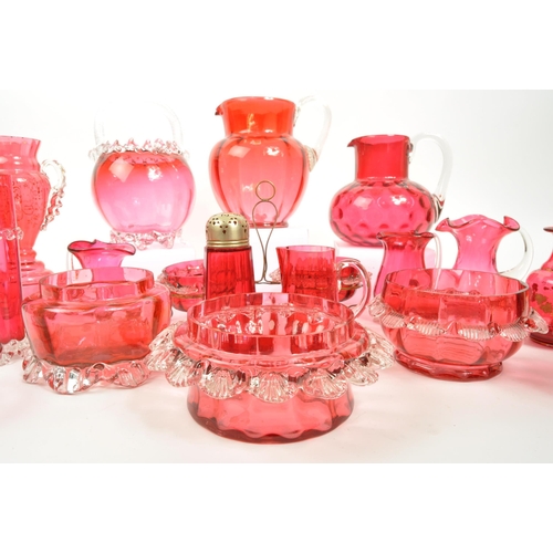 124 - A large collection of mid Century vintage cranberry glassware items to include jugs, bowls, vases, b... 