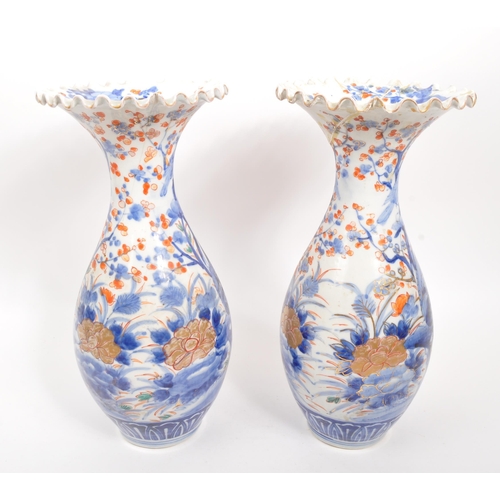 130 - A pair of early 20th century Japanese Meiji era china vases. Each vase raised on a rounded base havi... 