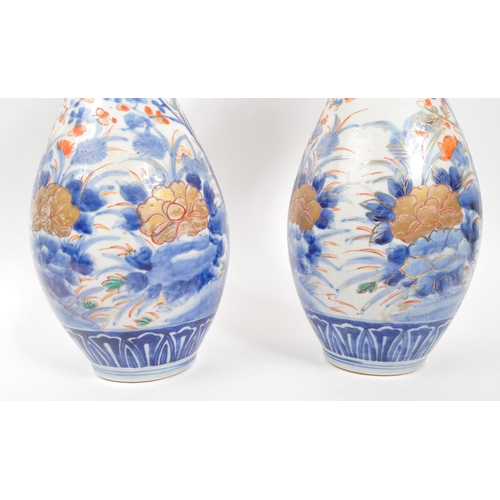 130 - A pair of early 20th century Japanese Meiji era china vases. Each vase raised on a rounded base havi... 