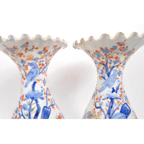 130 - A pair of early 20th century Japanese Meiji era china vases. Each vase raised on a rounded base havi... 