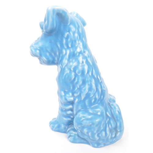 133 - A vintage 20th century ceramic pottery figurine / statue of a terrier dog in the Sylvac manner. In a... 