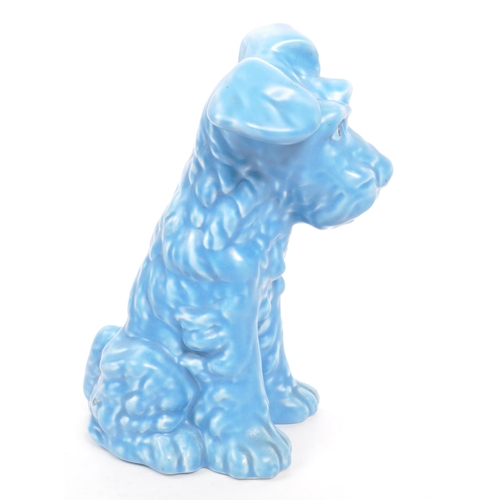 133 - A vintage 20th century ceramic pottery figurine / statue of a terrier dog in the Sylvac manner. In a... 