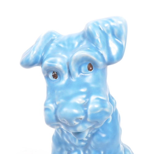 133 - A vintage 20th century ceramic pottery figurine / statue of a terrier dog in the Sylvac manner. In a... 