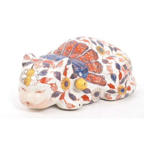 140 - A large early 20th Century ceramic Chinese imari figure in the form of a sleeping cat. Signed to bas... 