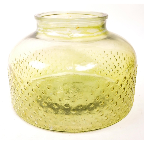 155 - A large 20th Century retro round squat green glass vase / carboy with textured circular design to bo... 