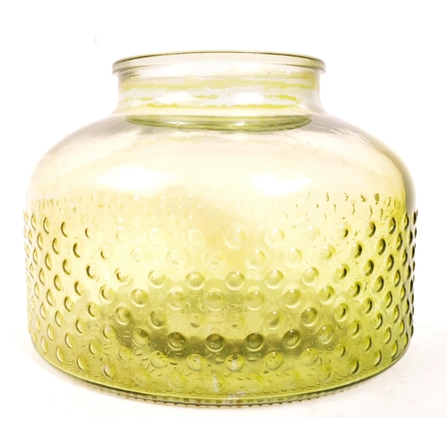 155 - A large 20th Century retro round squat green glass vase / carboy with textured circular design to bo... 