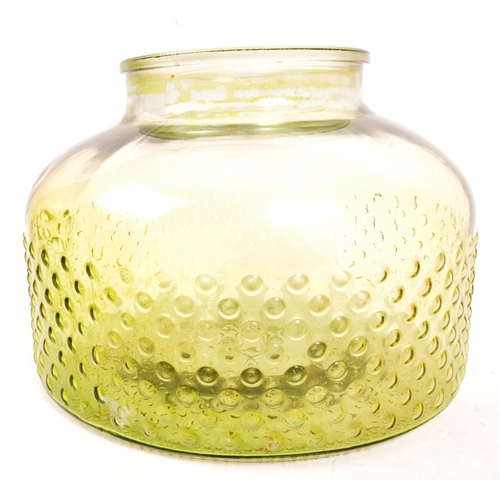 155 - A large 20th Century retro round squat green glass vase / carboy with textured circular design to bo... 