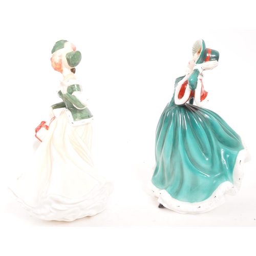 183 - Royal Doulton - Two contemporary porcelain china Christmas Day lady figurines. Christmas Day 2001 an... 