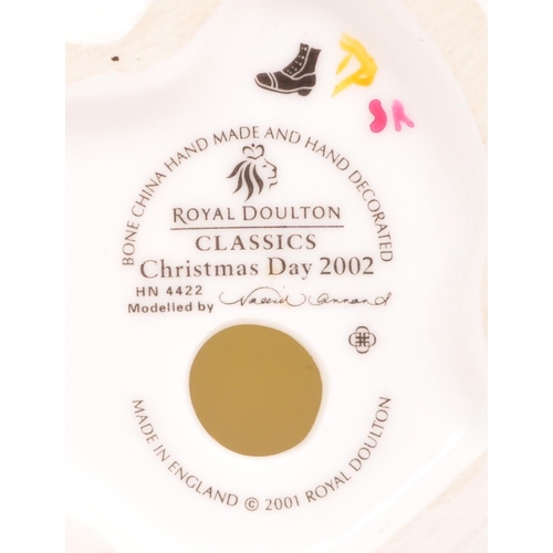 183 - Royal Doulton - Two contemporary porcelain china Christmas Day lady figurines. Christmas Day 2001 an... 