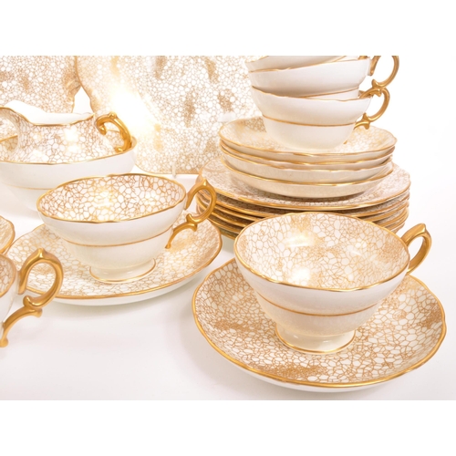 192 - Hammersley - A 20th century Hammersley 415 gold and white china tea service. The tea service having ... 