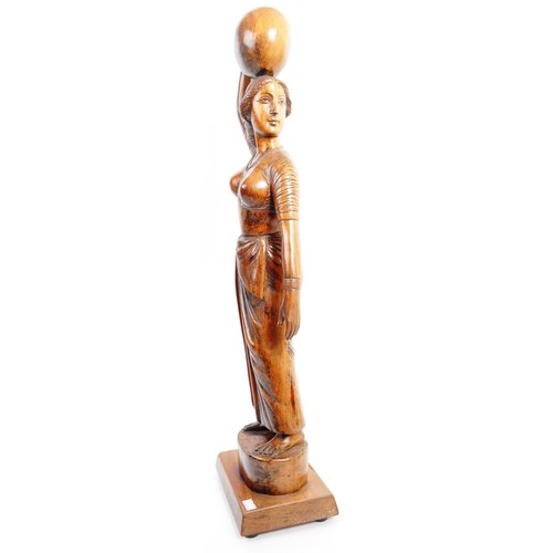 203 - A large 20th Century carved hardwood figurine / sculpture of Indian female carrying water bowl to he... 