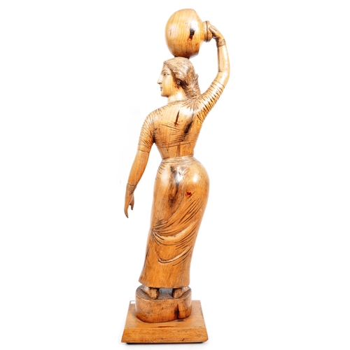 203 - A large 20th Century carved hardwood figurine / sculpture of Indian female carrying water bowl to he... 