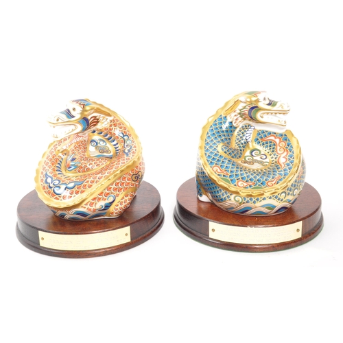 21 - Royal Crown Derby - A pair of porcelain china limited edition Royal Crown Derby millenium dragon pap... 