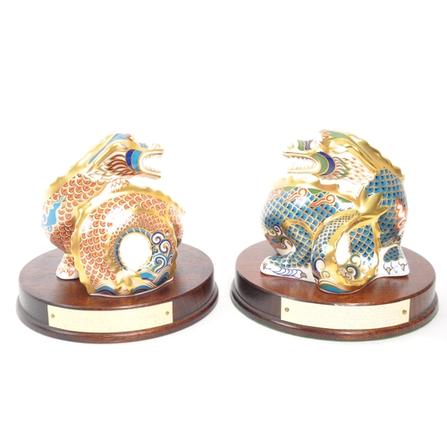 21 - Royal Crown Derby - A pair of porcelain china limited edition Royal Crown Derby millenium dragon pap... 