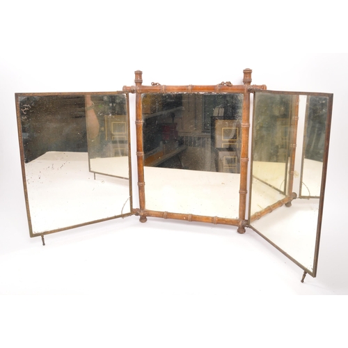 218 - An early 20th Century opening three piece triptych mirror having bamboo frame with Art Nouveau print... 