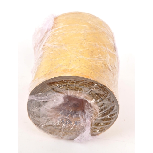 219 - A 22/24ct gold leaf roll. The roll having central cardboard tube with plastic backed gold leaf. Weig... 