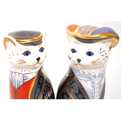 22 - Royal Crown Derby - Two porcelain china Royal Crown Derby paperweight figures from the Royal Cats co... 