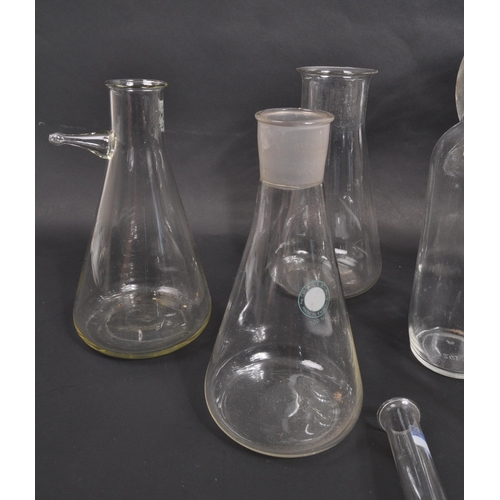 226 - A large collection of scientific / laboratory glass vessels comprising of beakers, conical flask, fl... 